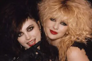 Two women with 1980s glam rock hairstyles.