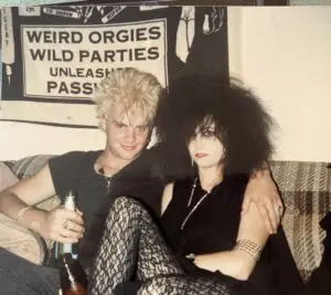 Two people with punk hairstyles sitting together.