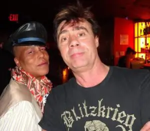 Two people posing in dimly lit bar