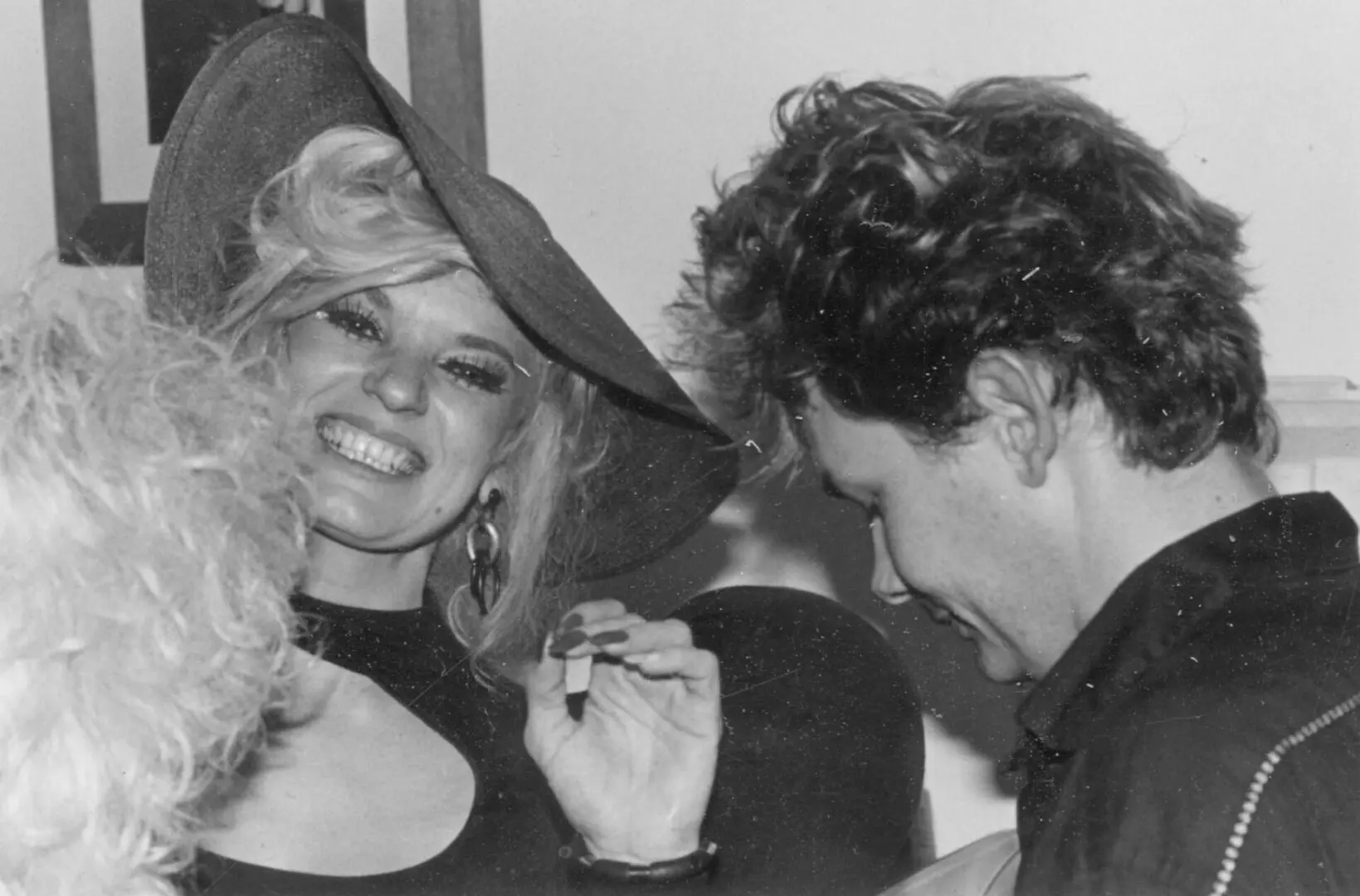 Smiling woman wearing hat beside a man