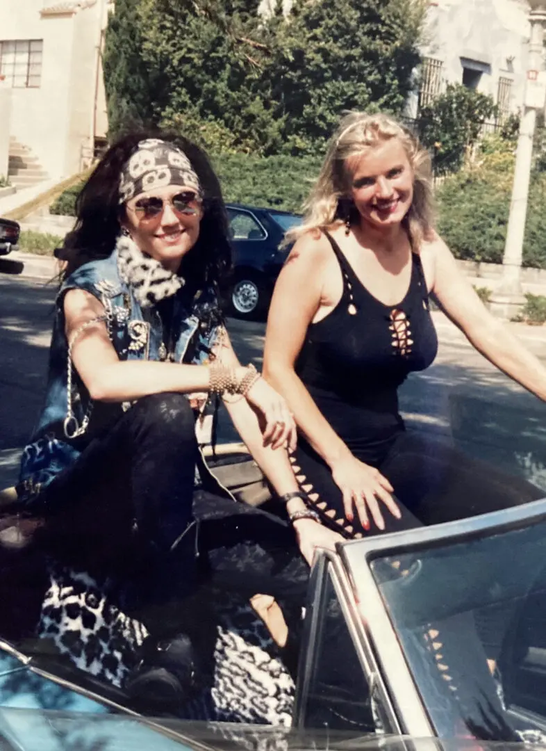 Two smiling women in convertible car