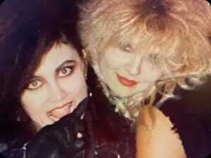 Two smiling women with dramatic makeup