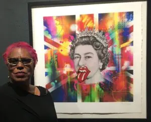 Person beside colorful crowned portrait with tongue