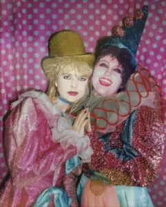 Two people in colorful clown costumes