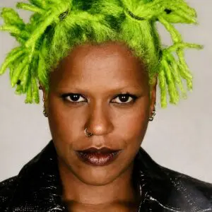 Close-up portrait of person with neon green dreadlocks