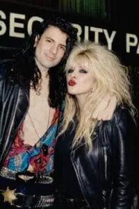 Two people with leather jackets and big hair